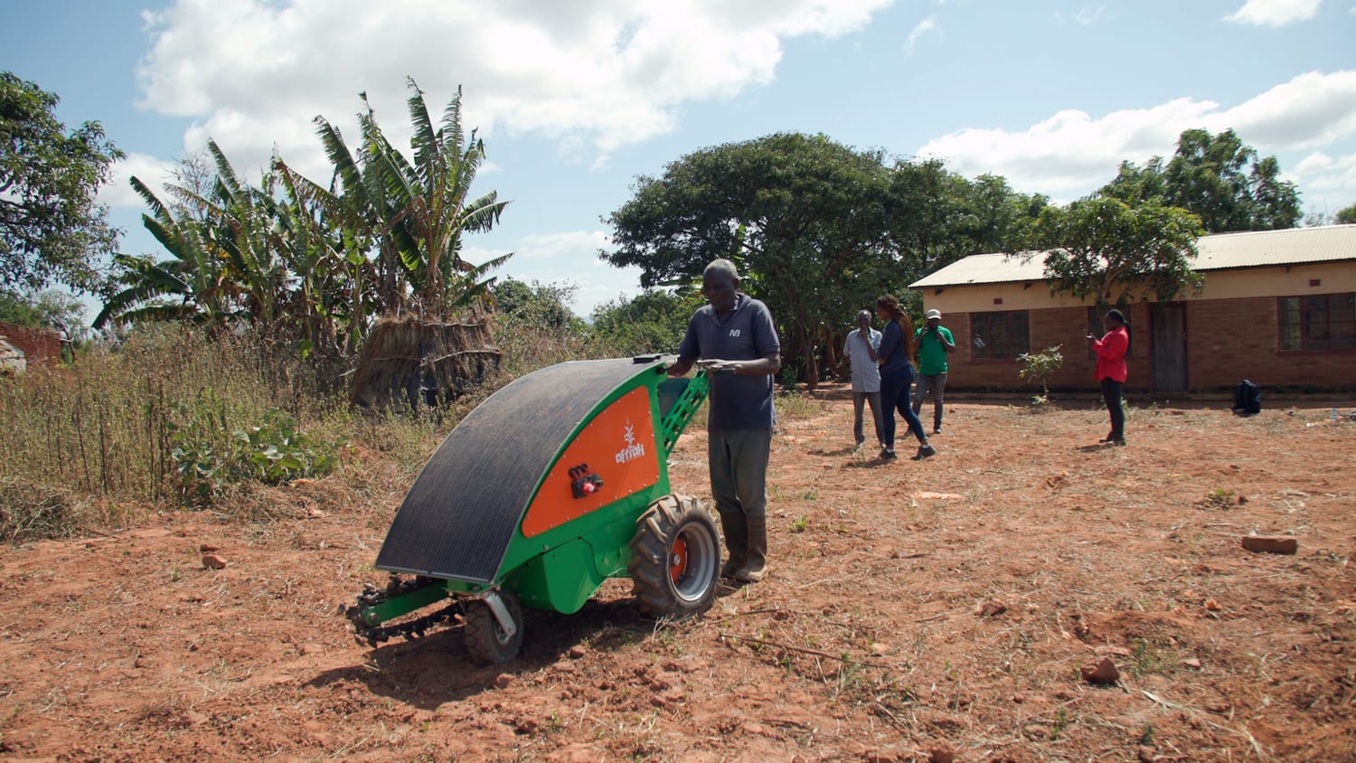 The tractor working under its solar panel at Emisizini